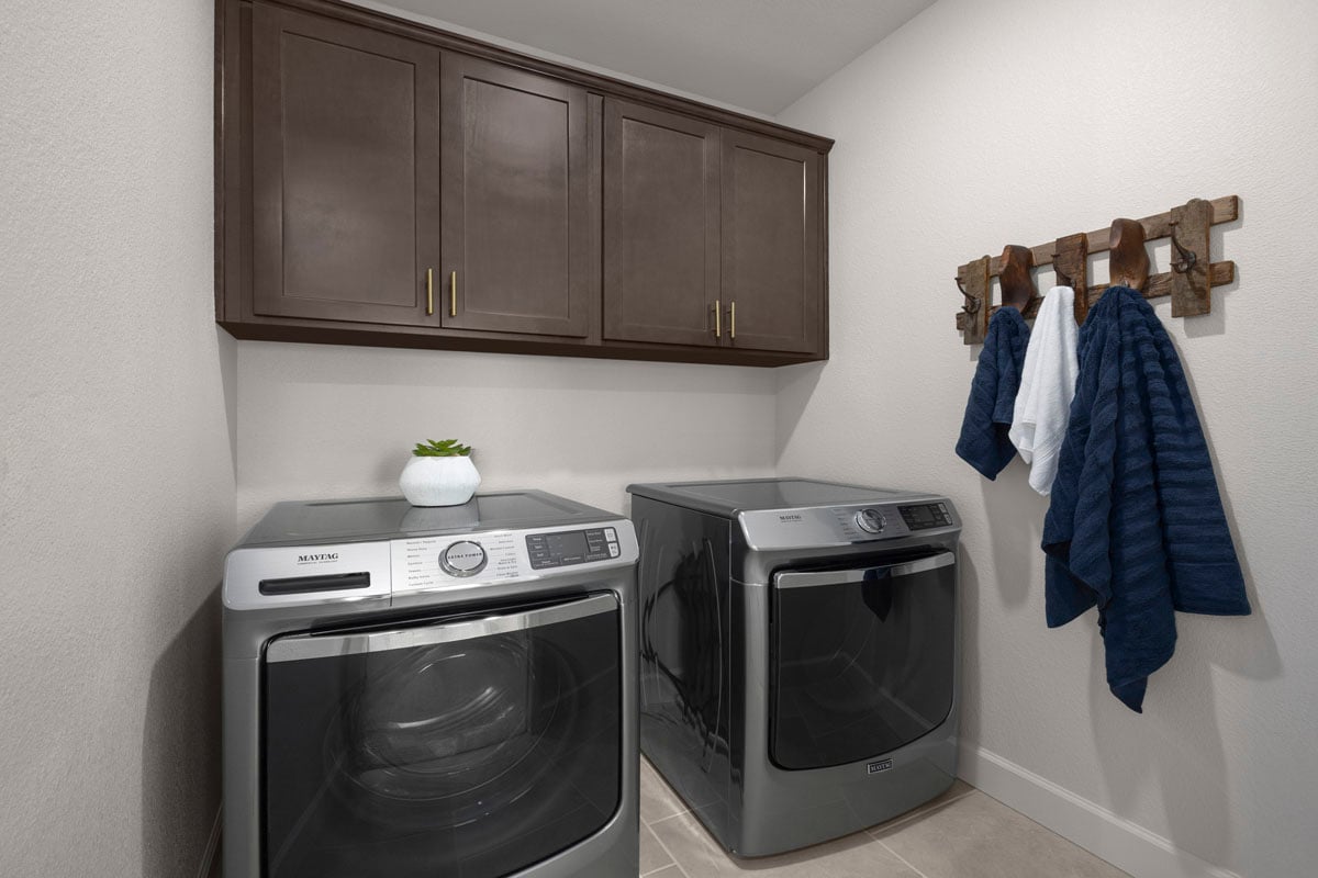Dedicated laundry room with upper cabinets