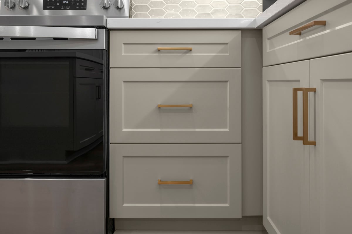 Optional Shaker-style thermofoil cabinets with gold pulls