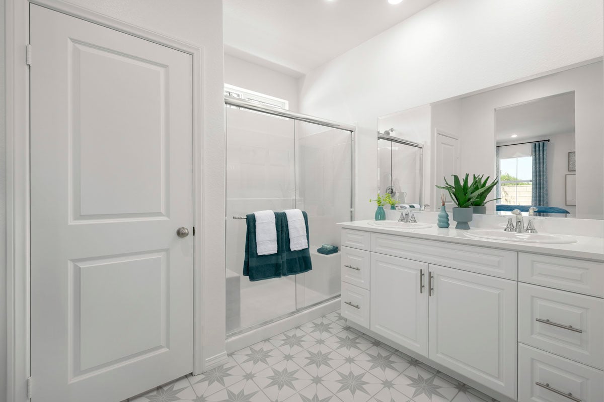 Walk-in shower and linen closet at primary bath
