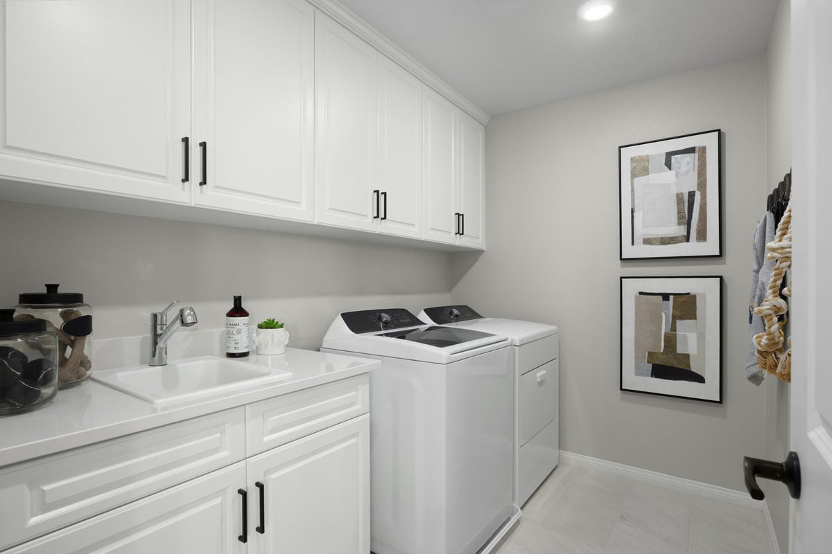 Optional upper and lower cabinets and sink at laundry room