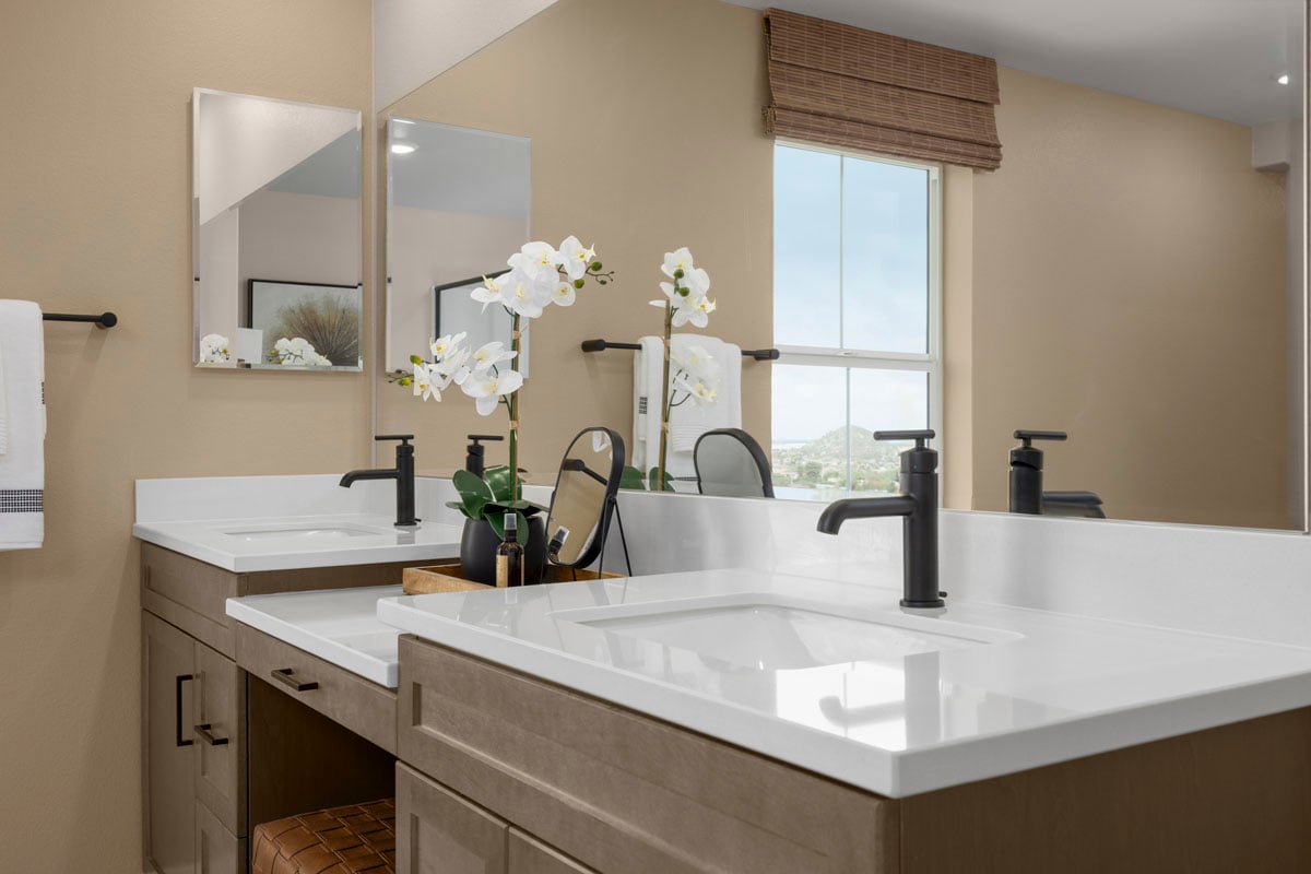 Optional extended dual-sink vanity with knee space at primary bath
