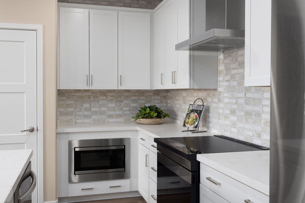 Wall-mounted hood and slide-in range