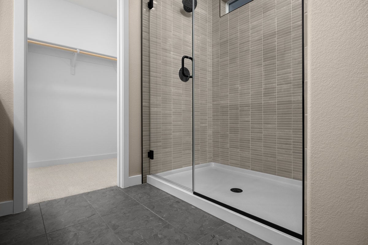 Walk-in shower with tile surround at primary bath