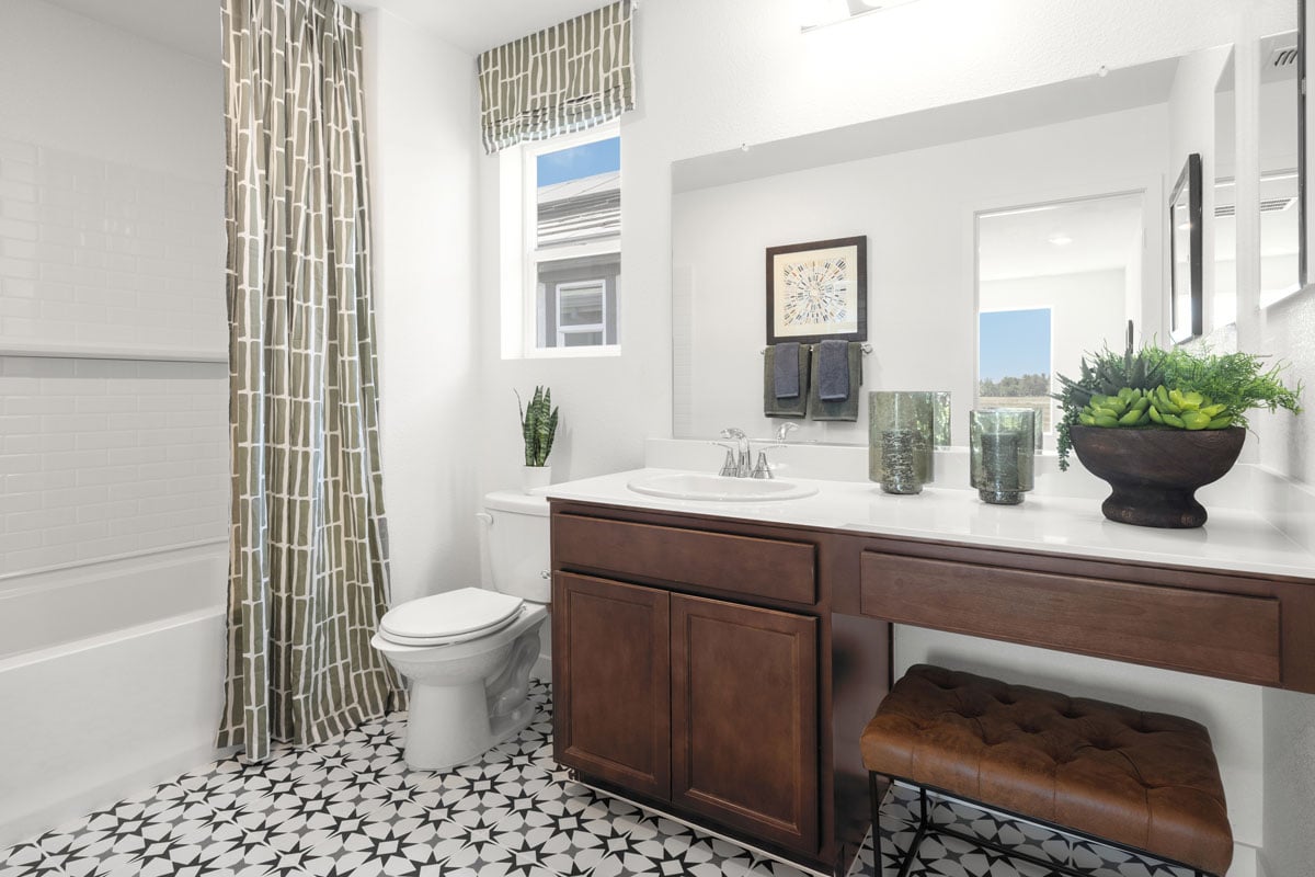 Extended vanity with knee space at secondary bath