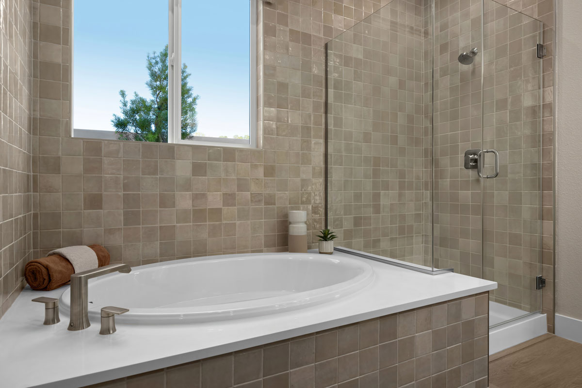 Tub and separate shower with custom tile surround at primary bath