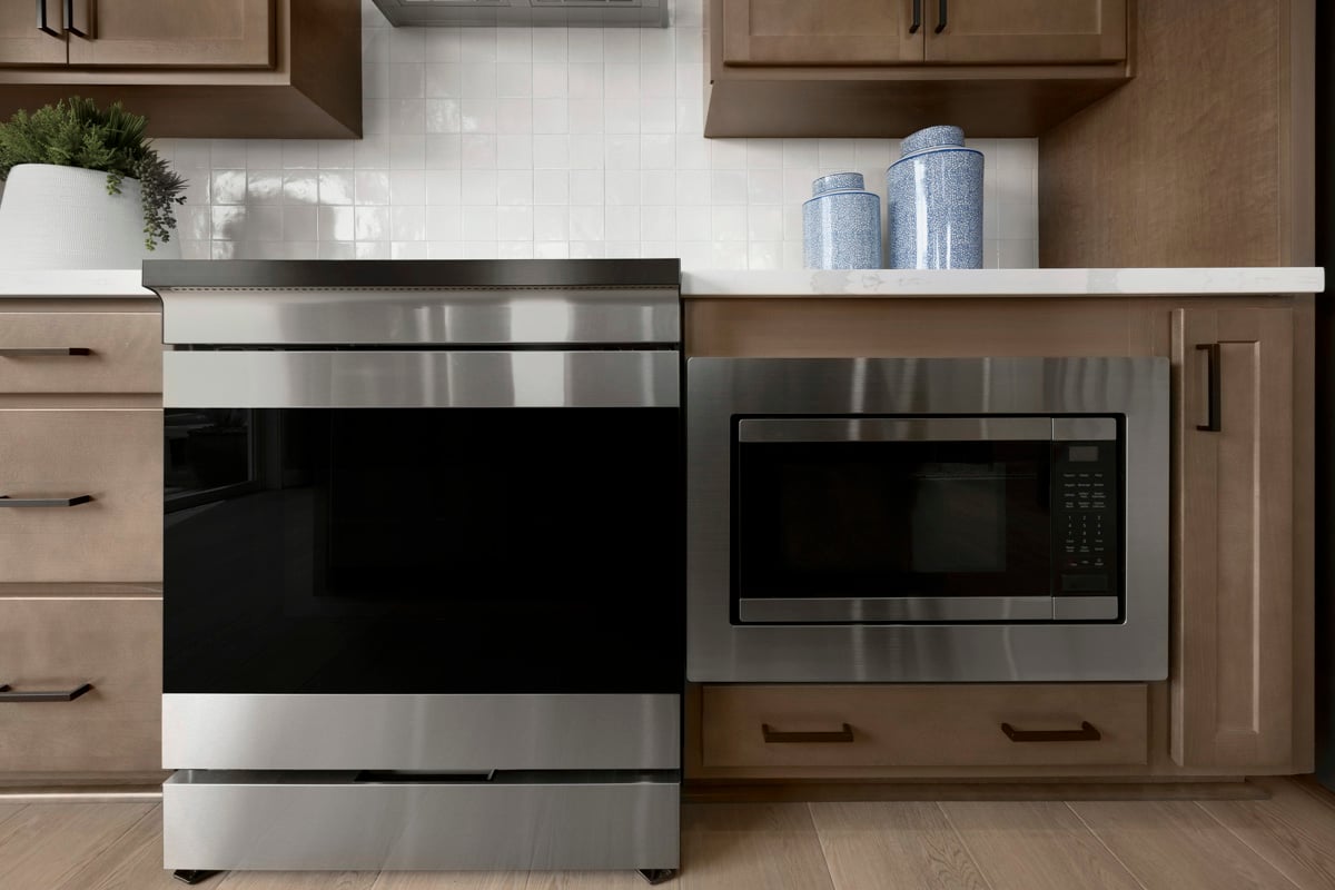 Slide-in range and lower cabinet microwave