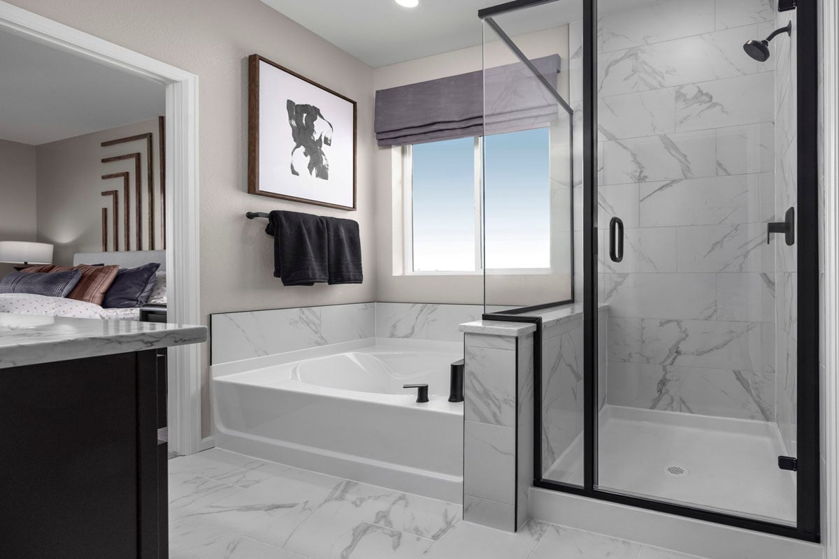 Walk-in shower with separate tub at primary bath