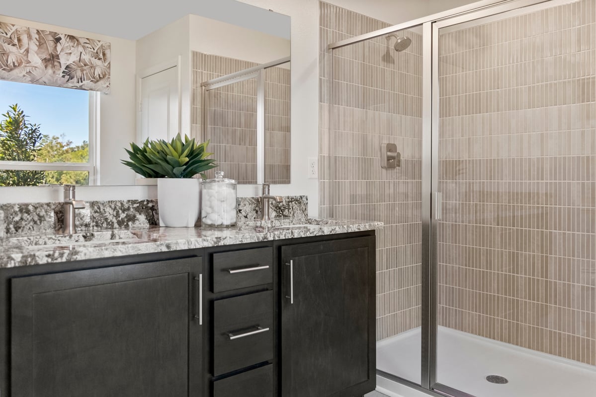 Walk-in shower with tile surround at primary bath