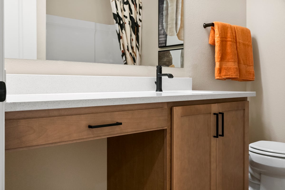 Extended vanity with knee space at secondary bath