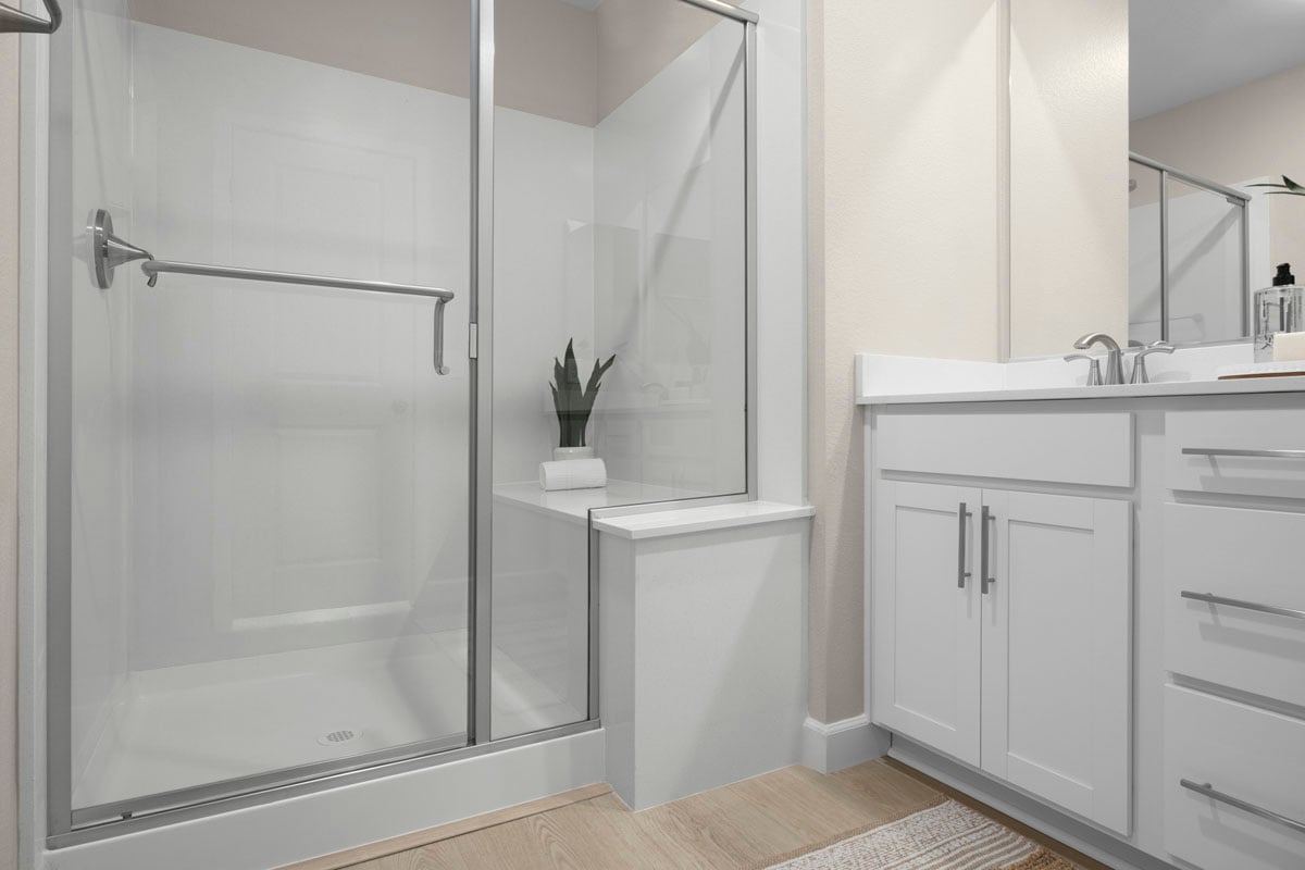 Enlarged walk-in shower with seat at primary bath