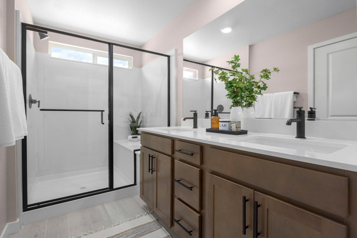 Enlarged walk-in shower with seat at primary bath