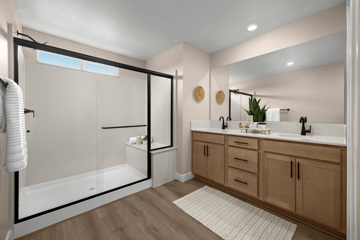 Enlarged walk-in shower with seat at primary bath