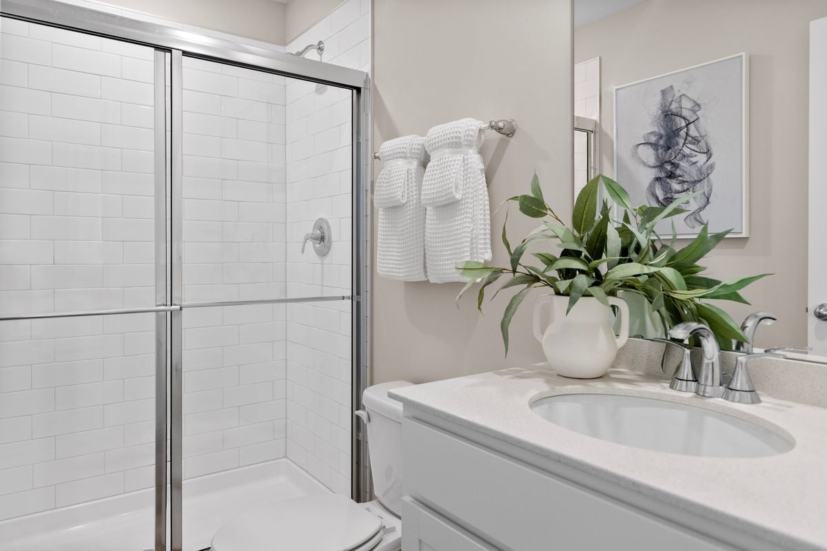 Walk-in shower with tile surround at primary bath