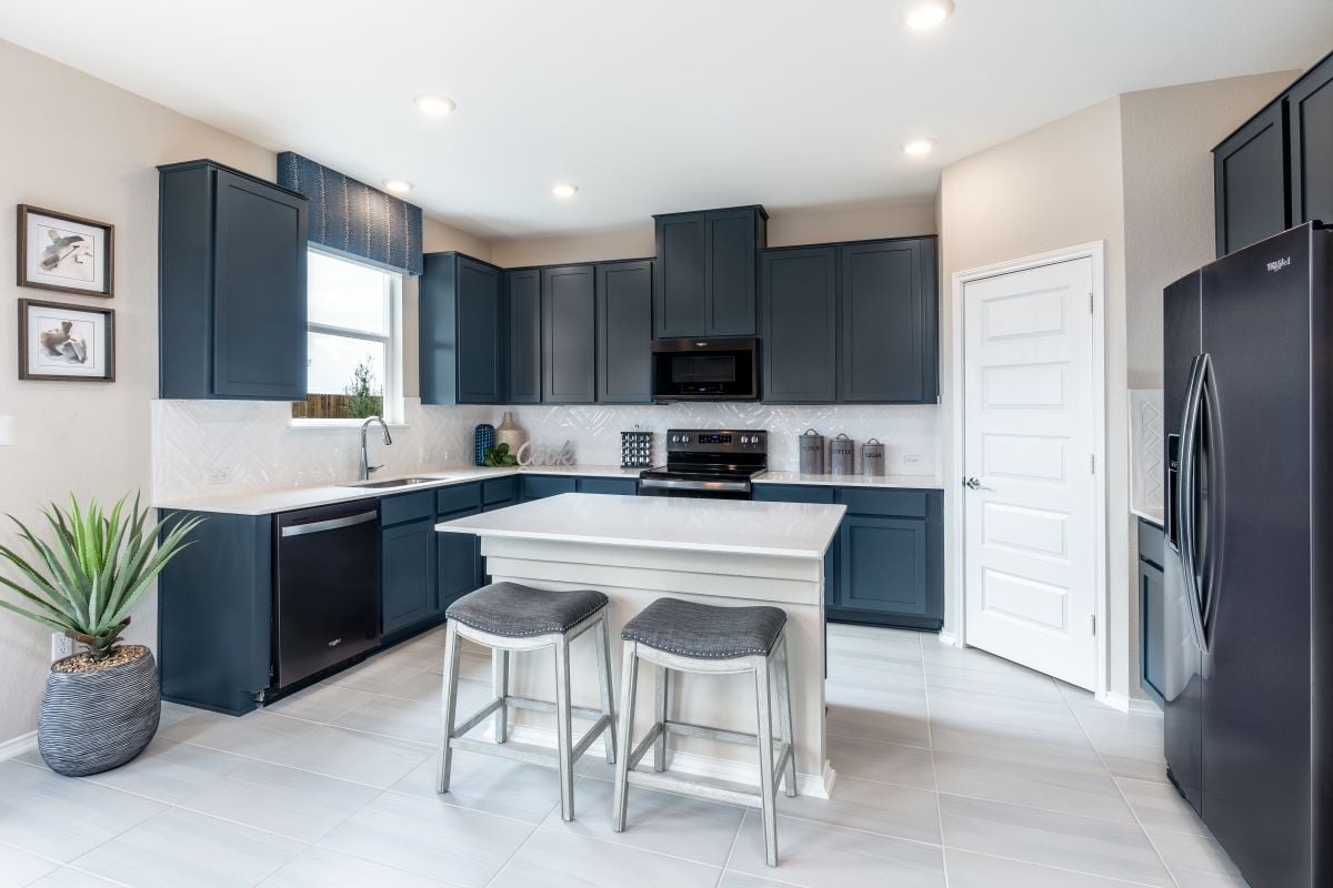 New Homes in Jarrell, TX - Sonterra-Cool Water Plan 2509 Kitchen as modeled at Berry Springs