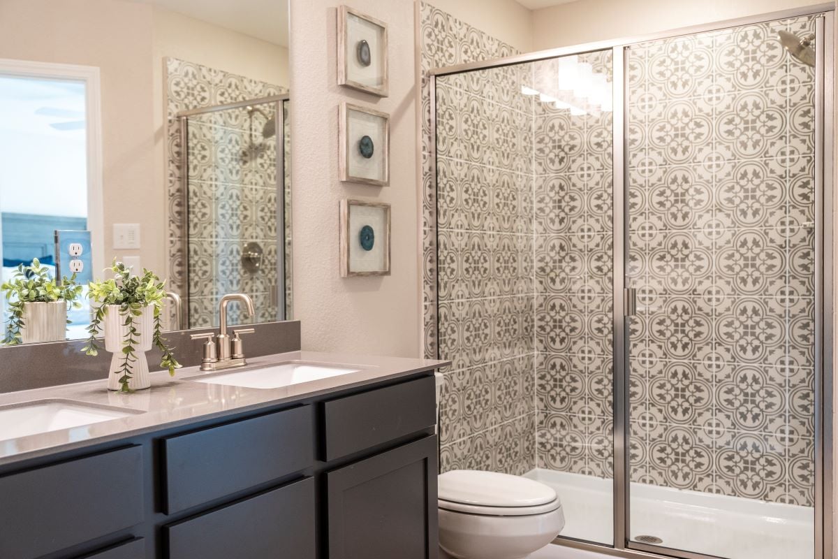 Walk-in shower with tile surround at primary bath
