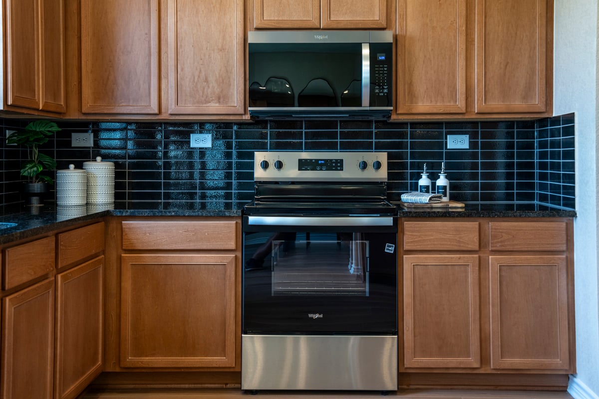  Granite countertops with glossy stacked tile backsplash