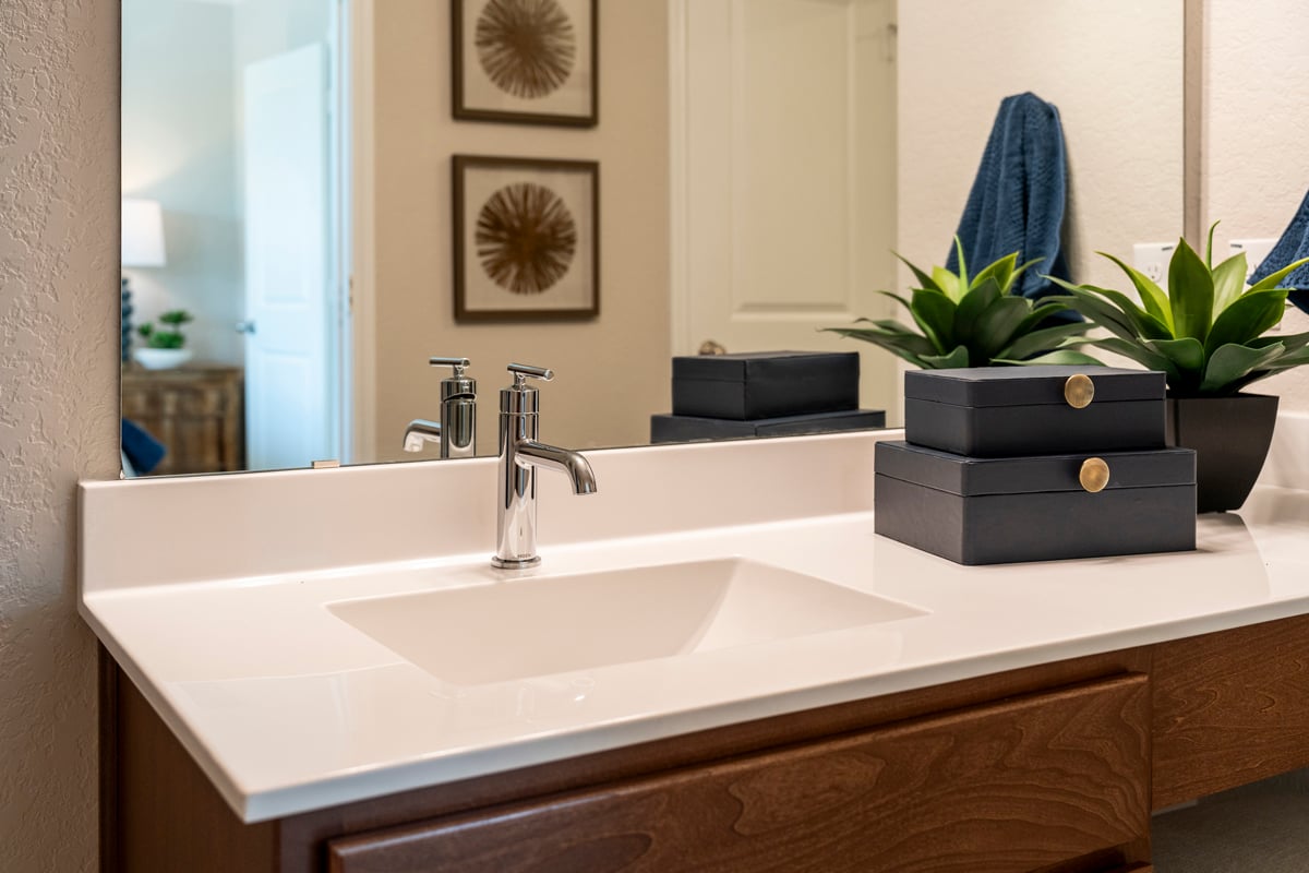 Cultured marble countertop with integrated sink at primary bath