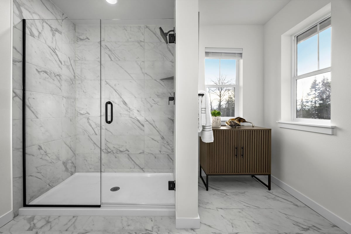 Walk-in shower with tile surround at primary bath